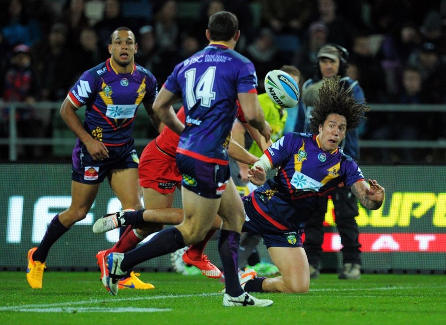 Kevin Proctor gets a pass away in the tackle:           NRL Rugby League, Round 20, Storm v Dragons at Napier NZ, Saturday July 25th 2013. Digital image by Dave Lintott, copyright nrlphotos.com