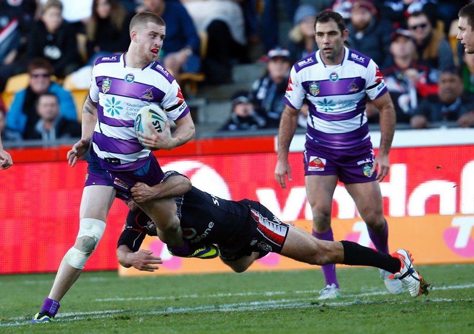Storm's Cameron Munster is tackled by Warriors Nathan Friend:           NRL Rugby League, Round 18, NZ Warriors v Melbourne Storm at Mt Smart, Sunday 12th July 2015. Digital image by Shane Wenzlick, copyright nrlphotos.com