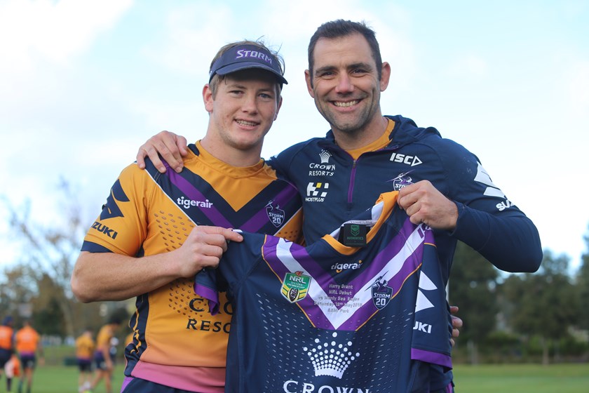 Cameron Smith presents youngster Harry Grant with his NRL debut jersey at Storm training.